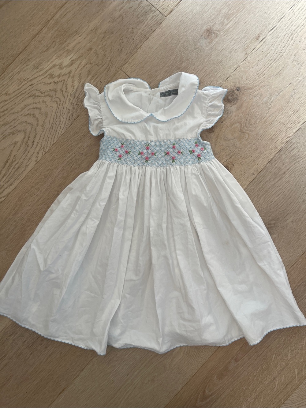 White Smocked Girls' Dress with Blue and Pink Floral Detail